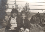 Susan and friend sitting by 6122 outside
