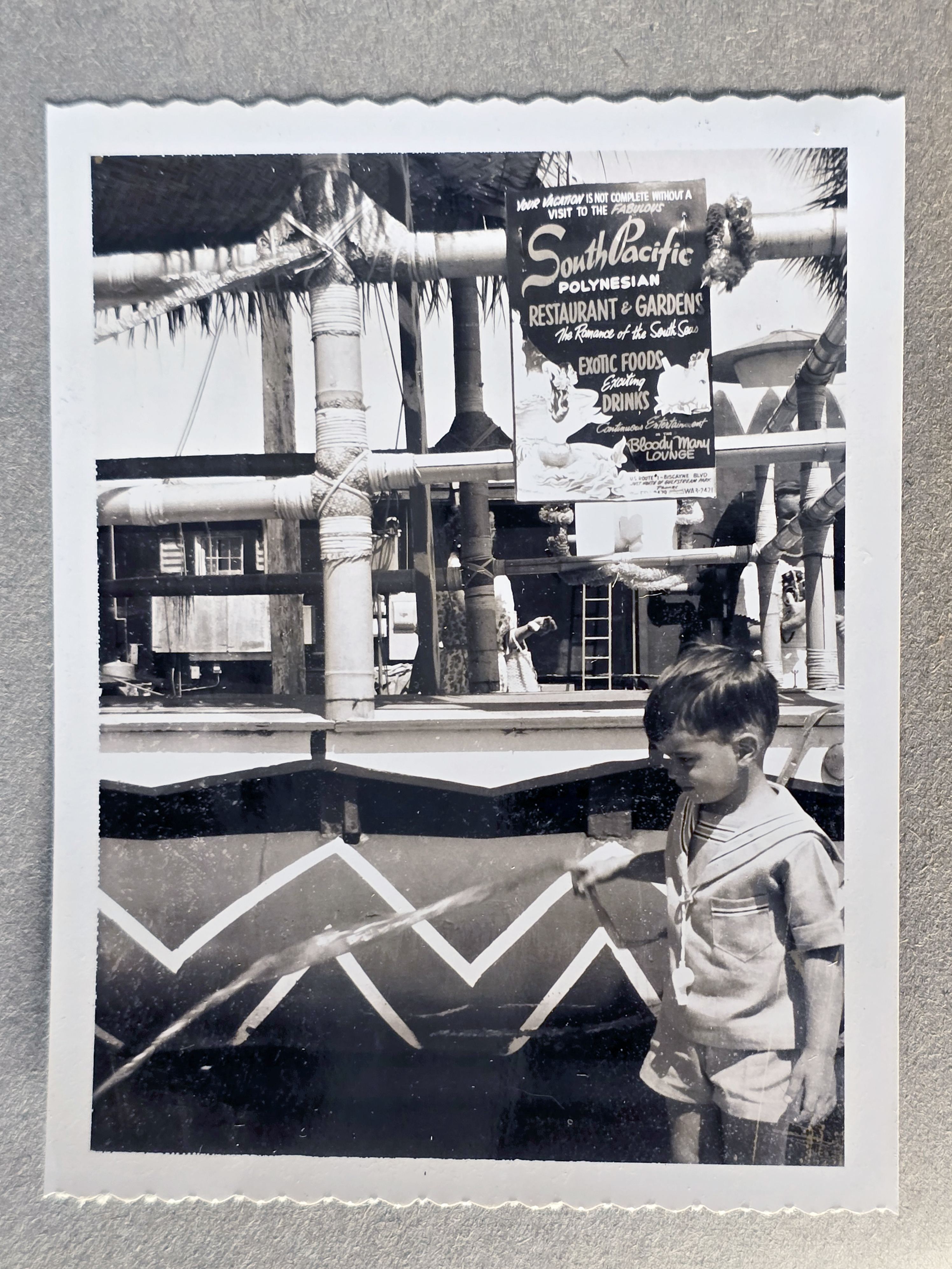 South Pacific Polynesian Restaurant - Alan by outdoor bamboo area and poster