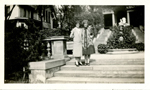 Edith Hague and Helen Dawson on steps at building.
