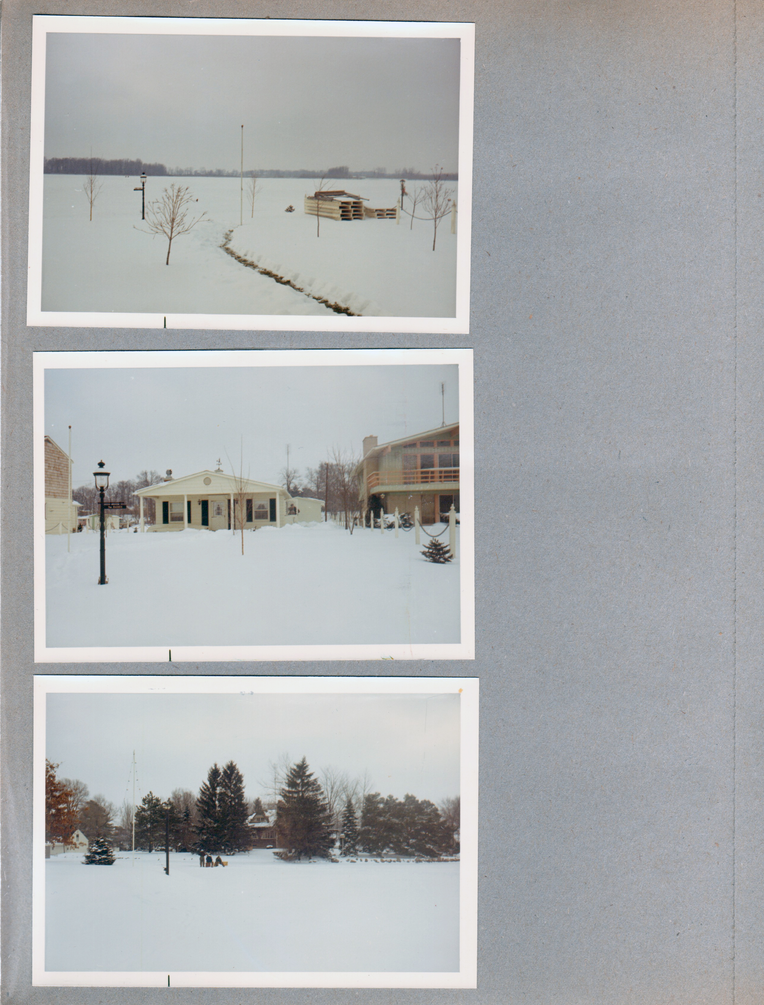 Wawasee - pier stacked in yard. Snow.